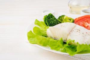 Steamed cod fish. Paleo, keto, fodmap healthy diet with vegetables photo