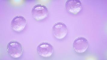 cuentas de gotas de vidrio abstractas sobre un fondo violeta neón foto