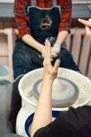 Woman making ceramic pottery on wheel, hands closeup. Concept for woman in freelance photo