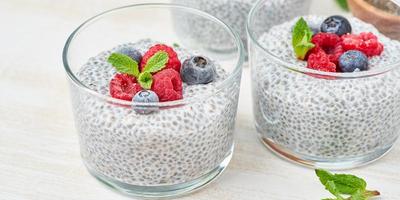 Banner with Chia pudding in bowl with fresh berries raspberries, blueberries. photo