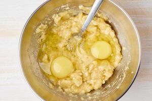 Mashed banana with egg. Step by step recipe. Homemade Banana bread. Top view, white wooden table. photo