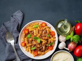Bolognese pasta. Fusilli with tomato sauce, ground minced beef photo