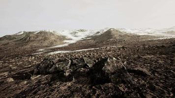 Sunrise in a rocky desert with shadows cast by the hills video