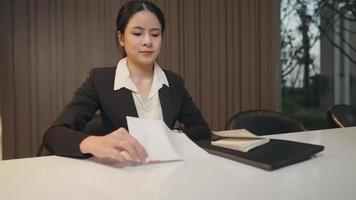Business people meeting in the office and signing agreement contract. the formal black suit handing personal  document while having company interviewing. Agreement and Partnership Concept, new jobber video
