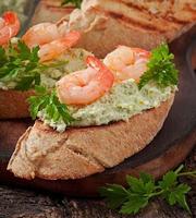 Bruschetta with a paste of green peas and shrimps photo