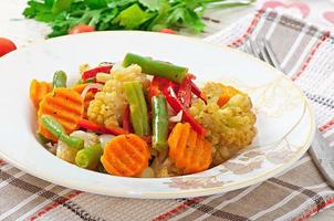 Steamed vegetables - cauliflower, green beans, carrots and onions photo