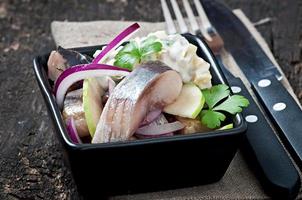 Herring salad with onion and green apple photo