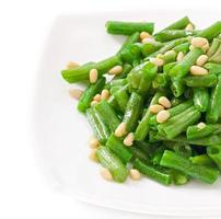 Fried green beans with cedar nuts photo