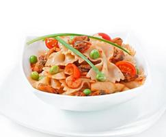 Farfalle pasta with seafood, cherry tomatoes and green peas photo