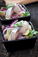 Herring salad with onion and green apple photo