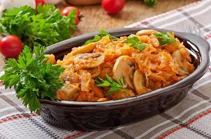 Stewed  cabbage with mushrooms and tomato sauce photo