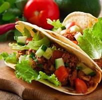 Mexican tacos with meat, vegetables and cheese photo