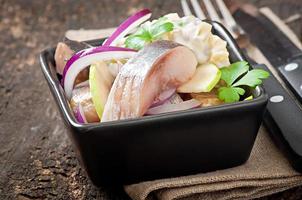 Herring salad with onion and green apple photo