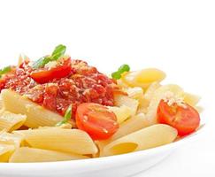 Penne pasta with bolognese sauce, parmesan cheese and basil photo