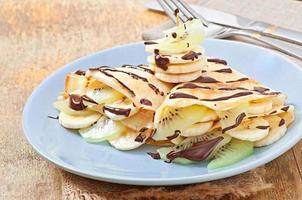 Pancakes with ice cream and chocolate sauce photo