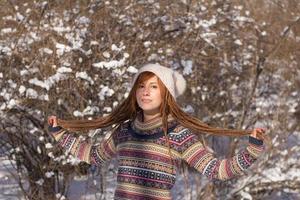 portraits of beautiful young woman in winter park photo