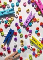 Colorful alphabet and number beads on white background photo