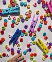 Colorful alphabet and number beads on white background photo