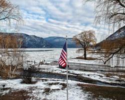 American flag on the Hudson river in winter photo