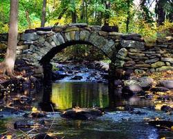 Stone arch over water in fall photo
