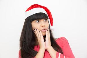 Young woman in santa cap scared photo