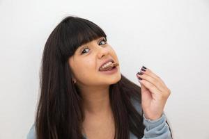 Young woman eating chocolate photo