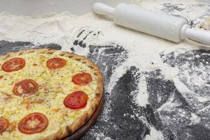 Concept of preparation of pizzas in a pizzeria or at home. Gourmet pizza. Traditional Brazilian mozzarella pizza. photo