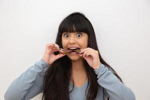 Young woman eating chocolate photo