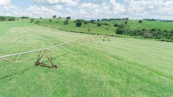 Agricultural irrigation system on sunny summer day. An aerial view of a center pivot sprinkler system. photo