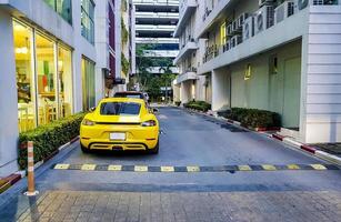 Yellow sports car parked in Bangkok Thailand.