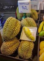 Smelly fresh durian fruit Thai night market street food, Bangkok. photo