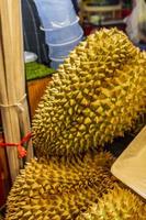 Smelly large durian fruits Thai night market street food Bangkok. photo