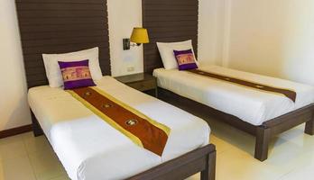 Stylish Thai hotel room with wood purple pillows Phuket Thailand.