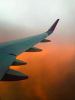 Hazy airplane wing view sunny cinematic panorama during flight over land copy paste vertical background photo