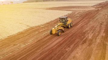 Tractor and plowing the ground for a future plantation. Tractor plowing and preparing the soil. photo