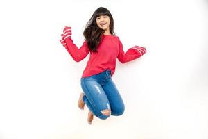 happiness, freedom, motion and people concept - smiling young woman jumping photo