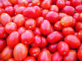 Pile of red tomatoes for sale in market photo