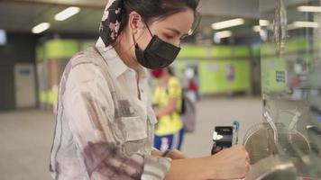 Attractive asian woman fills out questionnaire or registration form at sky train reception counter, well organized girlfriend asking writing personal information for her boyfriend, customer privileges video