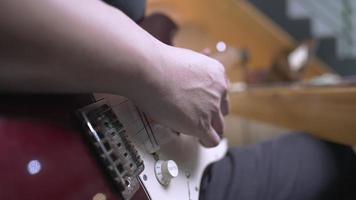 close-up mão de pele clara do guitarrista tocando guitarra elétrica fazendo prática solo, instrumentos musicais modernos, ritmo e blues, groove da música, membro da banda de rock praticando para performance ao vivo video