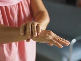 mujer cogida de la mano trastorno raro cuerpo sistema inmunitario ataca nervios, síndrome de guillan barre, vacuna covid-19 tratamiento de coronavirus foto