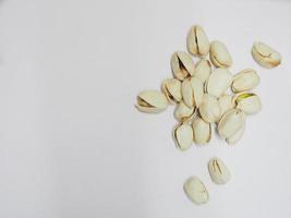 Pistachio dried bean on white background, top view photo