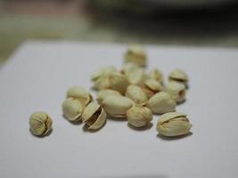 Pistachio dried bean on white background, top view photo