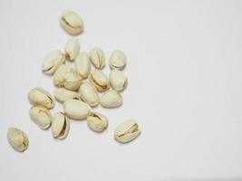 Pistachio dried bean on white background, top view photo