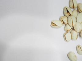 Pistachio dried bean on white background, top view photo