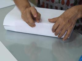 woman use paper wrapping a box Homemade care packages photo