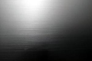 Fondo abstracto de textura de papel brillante negro gris, papel tapiz o artes de fondo. papel de envolver vacío, póster, cartón brillante para elemento de diseño decorativo, diseño de superficie lisa de acero inoxidable foto