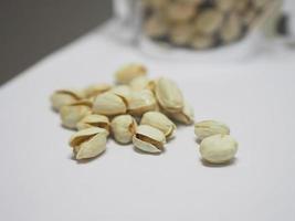 Pistachio dried bean on white background, top view photo