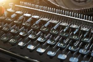Keyboard of a retro typewriter, illuminated by sunlight. photo
