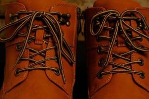 Laced brown winter boots.Background men's and women 's shoes. photo