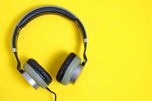 Wired headphones in khaki on a yellow background. photo